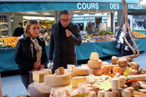 Tasting cheese at Rue de Buci food market in St Germain des Pres, Paris